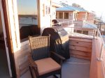 The balcony has a weber BBQ grill and 2 comfortable rocking chairs.